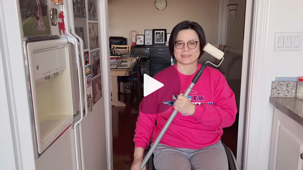 video thumbnail with a woman in a wheelchair brandishing a long-handled lint roller