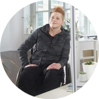 A woman sits in a wheelchair